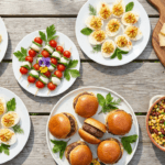 Overhead flat-lay of summer party appetizers including skewers, deviled eggs, sliders, and a cheese board