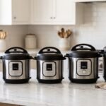 A lineup of five electric pressure cookers of varying sizes on a white marble kitchen counter